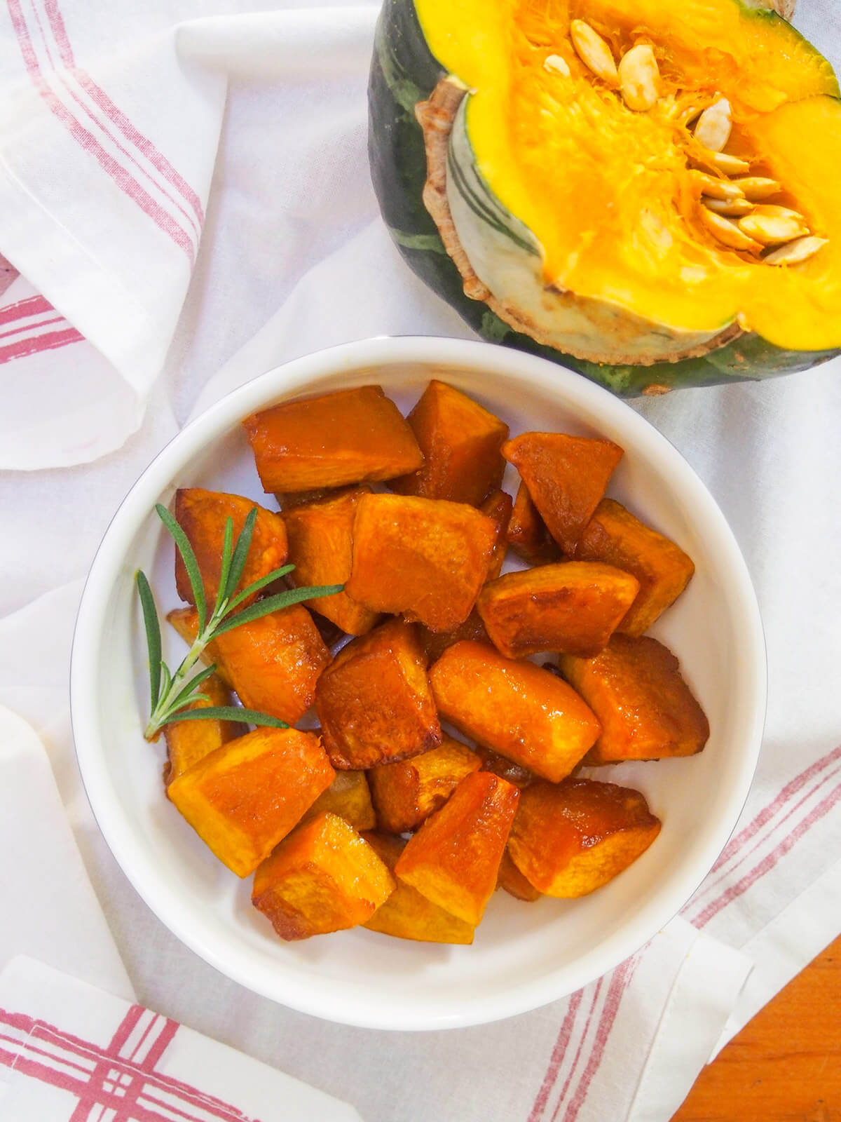 bowl of roasted squash with half a buttercup squash above