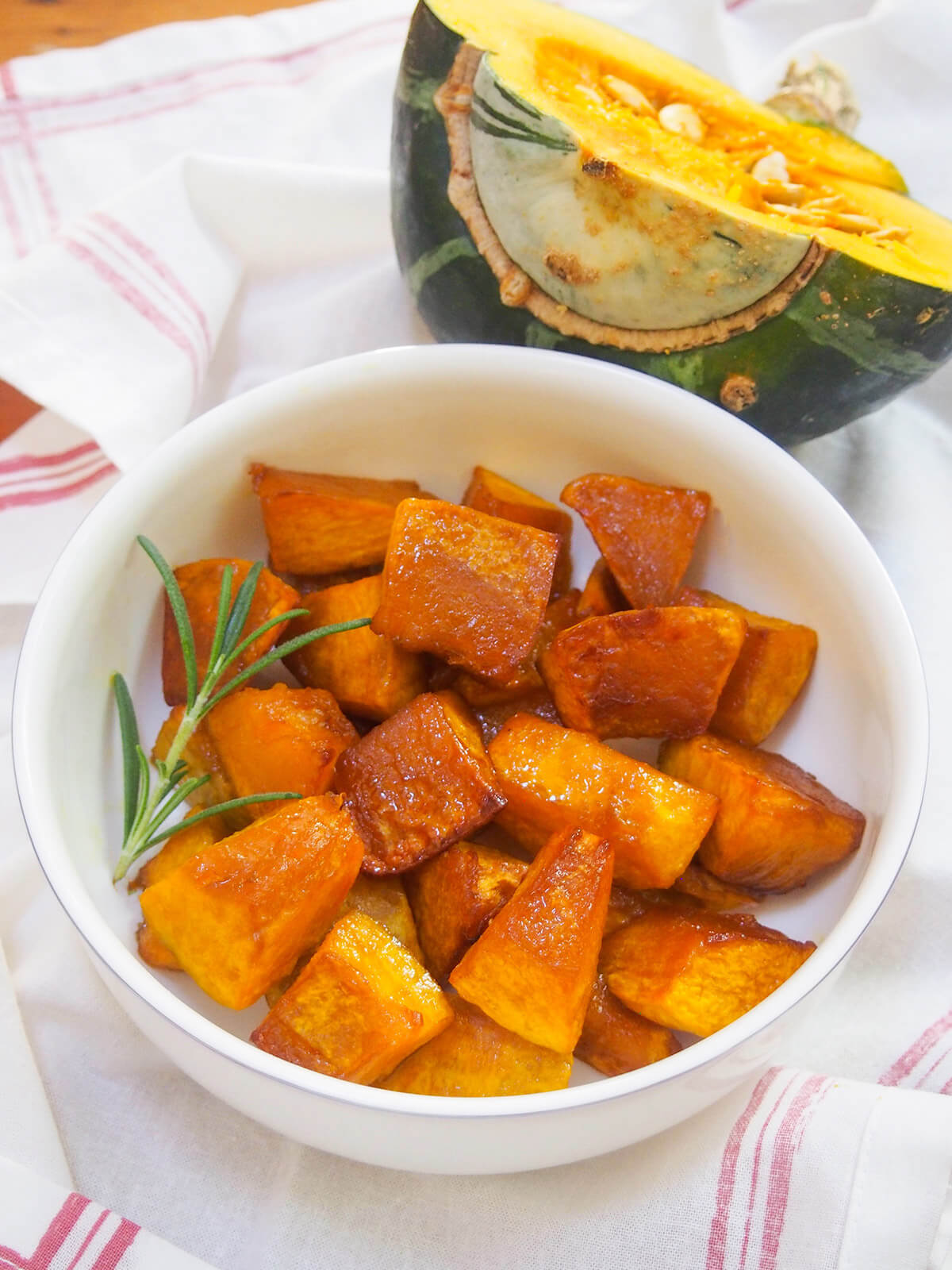 bowl of maple roasted buttercup squash with half squash behind