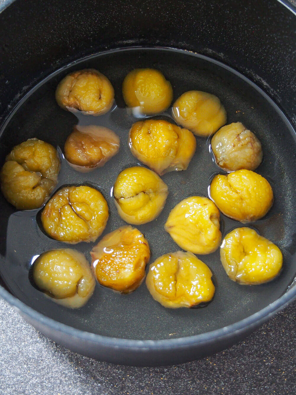 chestnuts soaking in pot of syrup