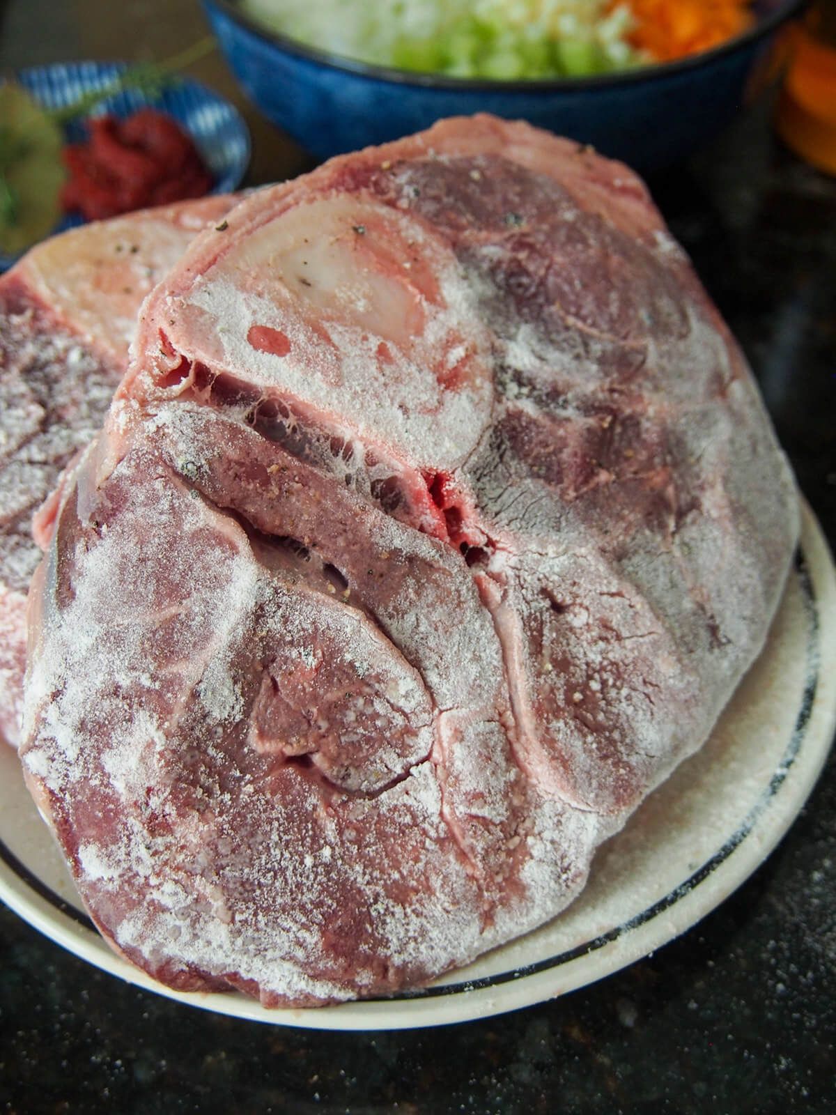 flour dusted beef for osso bucco flour-dusted beef shanks on plate