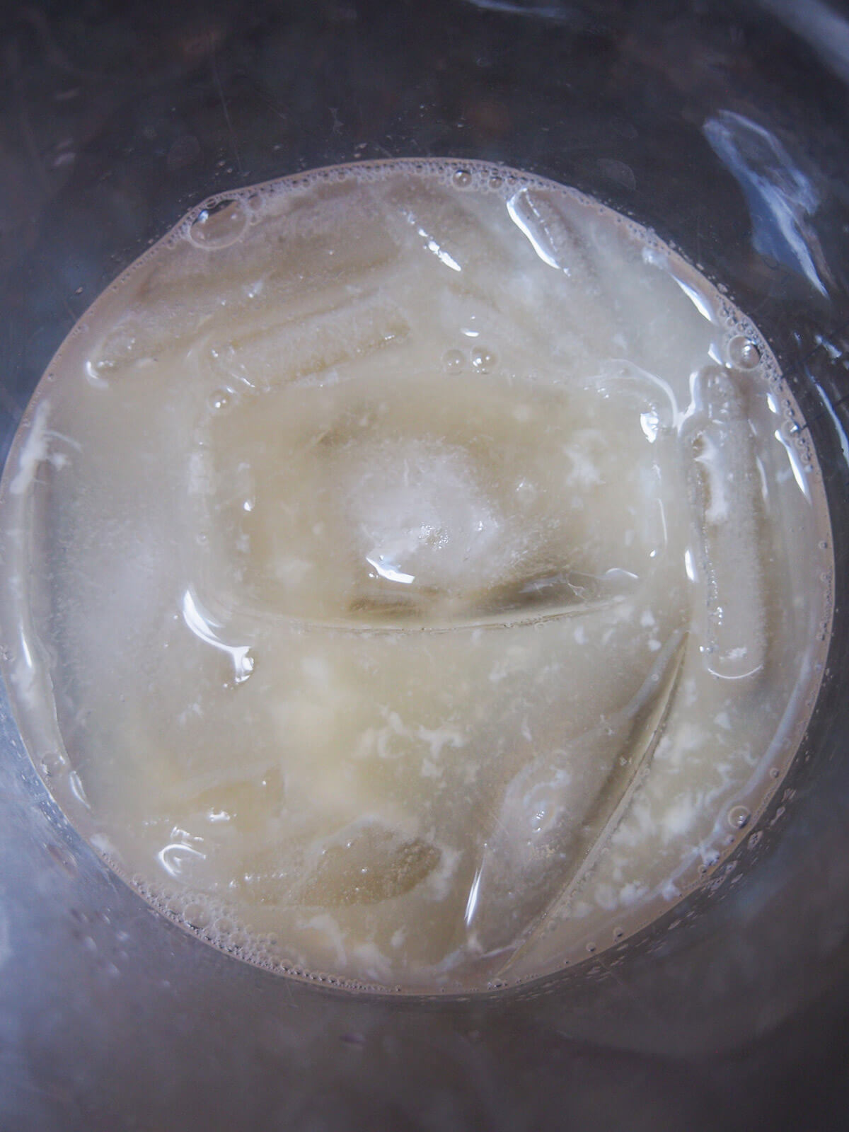 ingredients for cocktail in shaker with ice