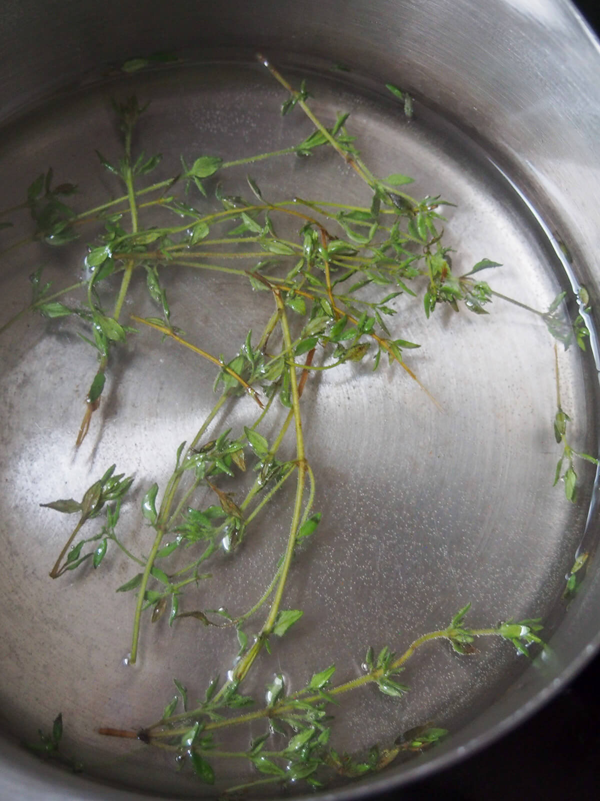 thyme sprigs in pan with syrup