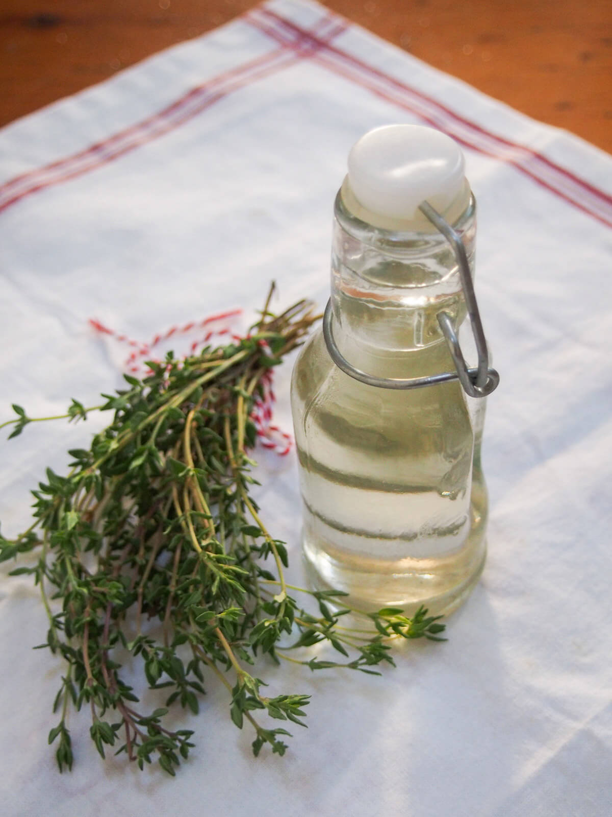 bunch of thyme and bottle of syrup side by side