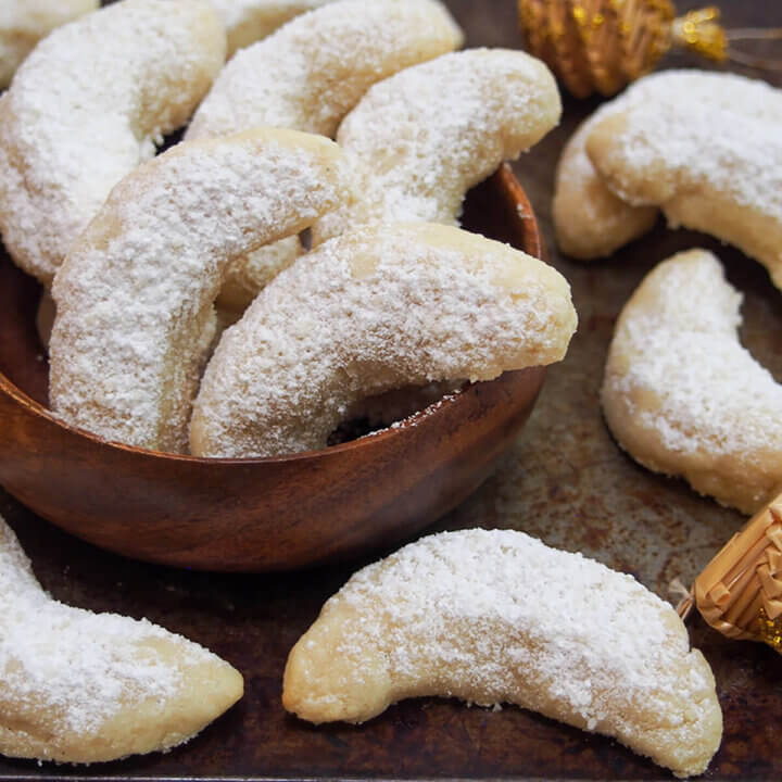 vanillekipferl vanilla crescent cookies stacked in small bowl