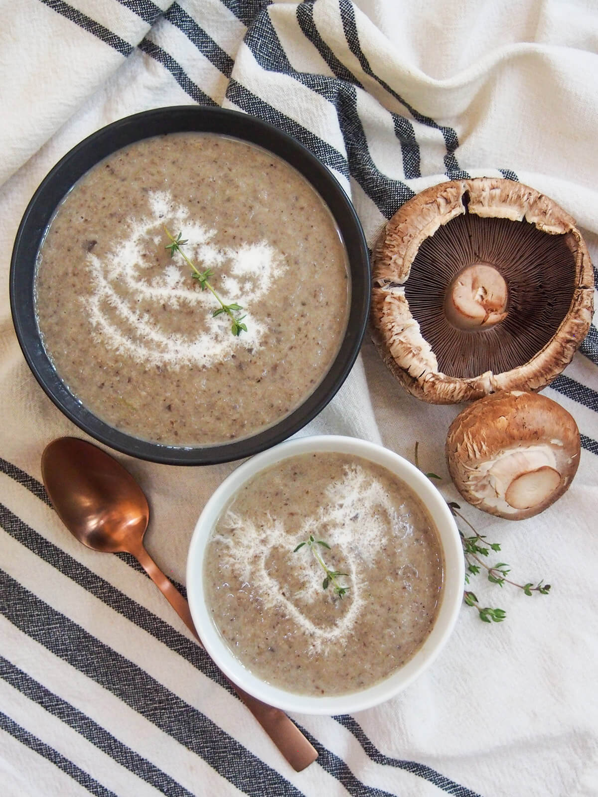 This wild mushroom soup uses a blend of mushrooms to add more depth of flavor, but with all that wonderful earthiness and smooth creaminess you would expect. It's easy to make, comforting and delicious. two bowls of wild mushroom soup from overhead