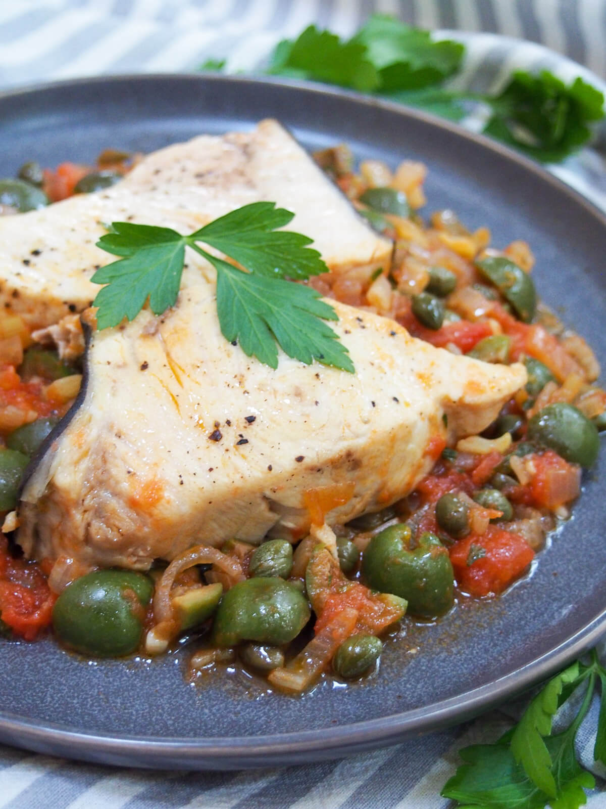 close up of Sicilian swordfish with olives and capers