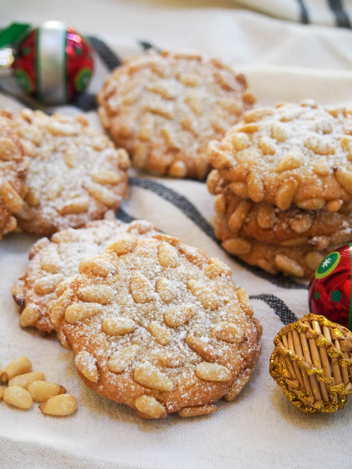 pignoli cookies with stack of cookies behind