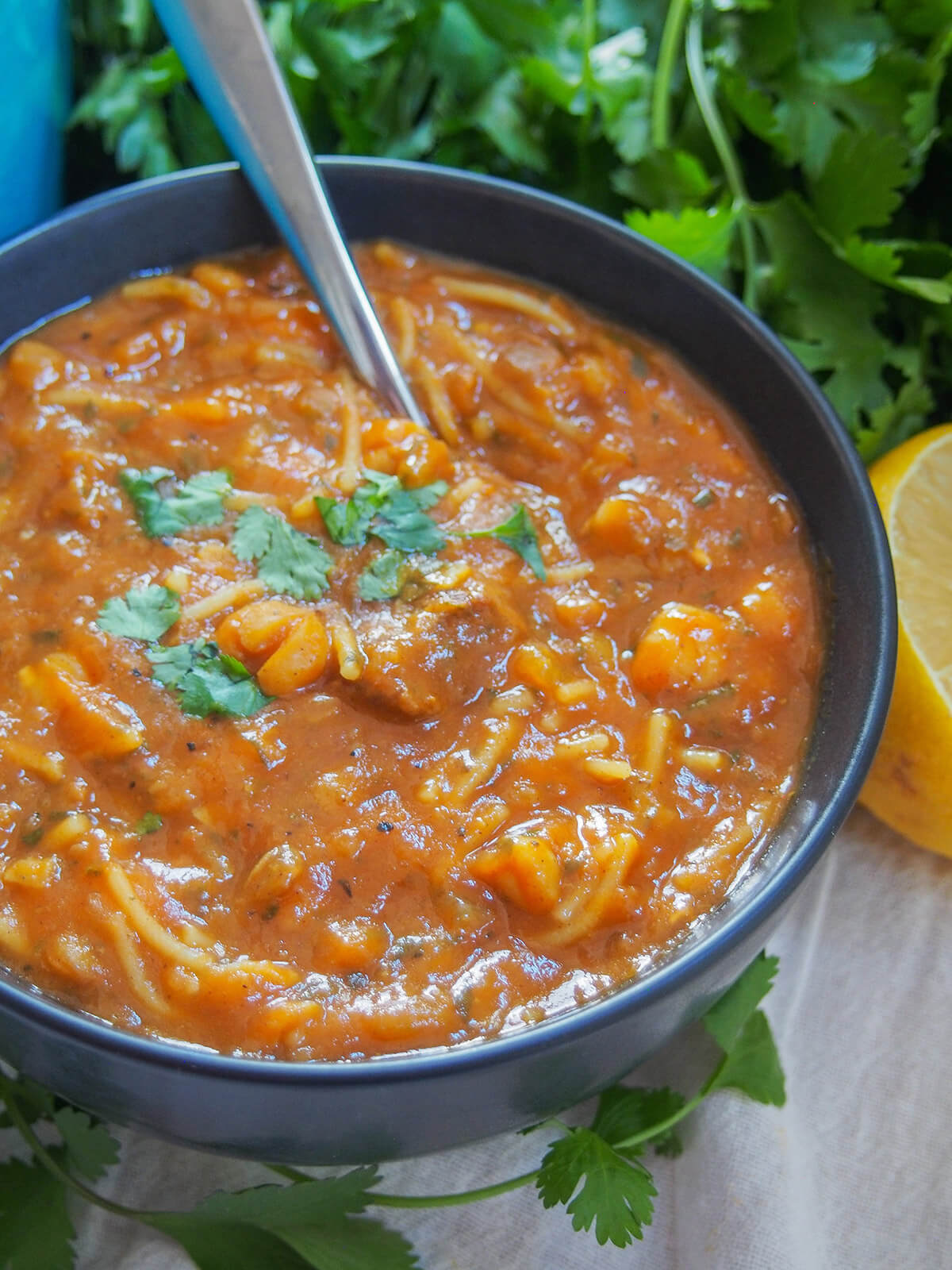 bowl of Moroccan lentil and chickpea soup with spoon in bowl