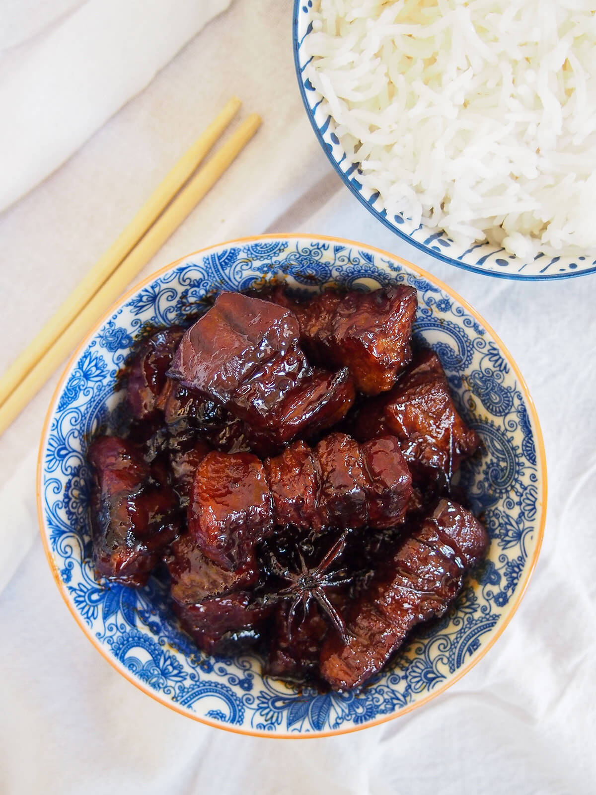 bowl of Hong shao rou red braised pork belly with bowl of rice above