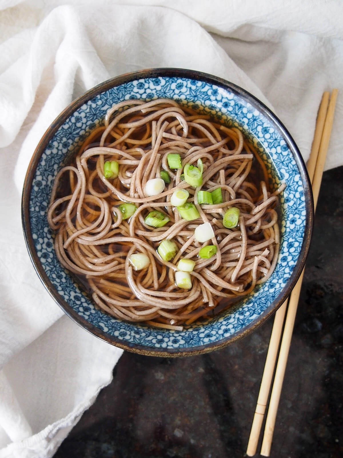 bowl of Toshikoshi soba new year soba noodles from overhead with chopsticks to side