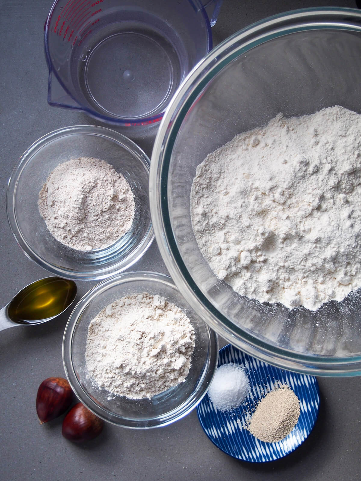 bowls with different flours, water and plate with salt and yeast