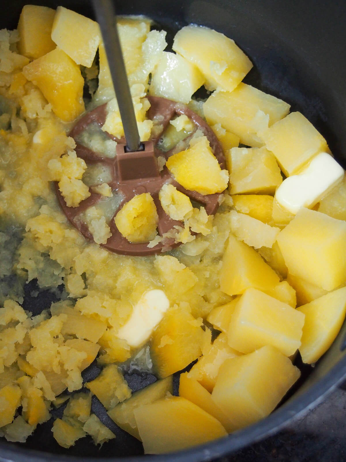 mashing rutabaga for mashed rutabaga or swede mash mashing rutabaga in pan with butter