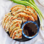 plate of Chinese scallion pancakes with dipping sauce