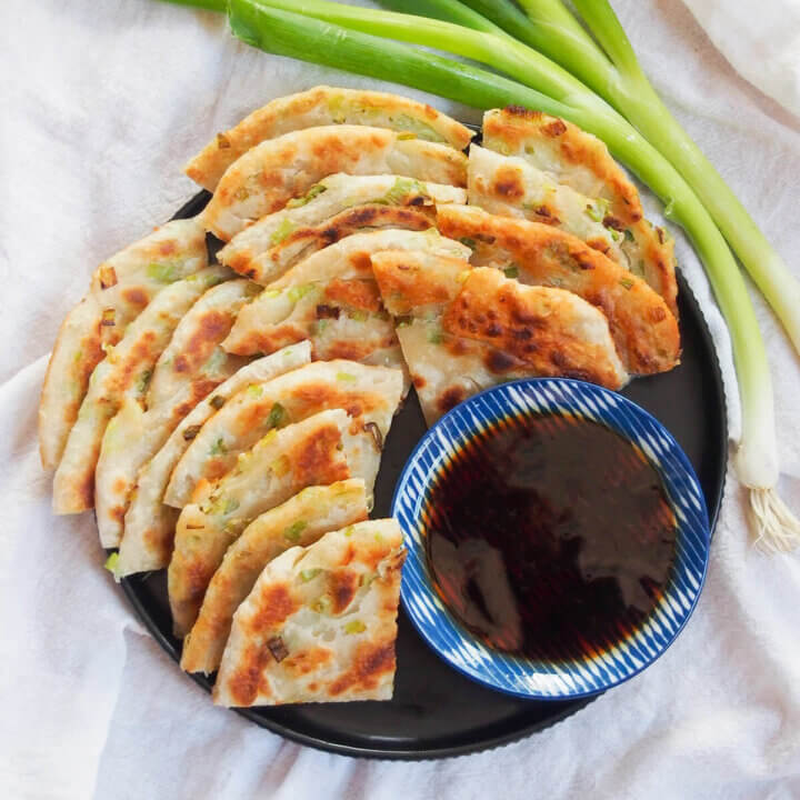 plate of Chinese scallion pancakes with dipping sauce