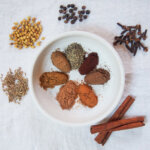 piles of spices in dosh to make Lebanese seven spices aka baharat