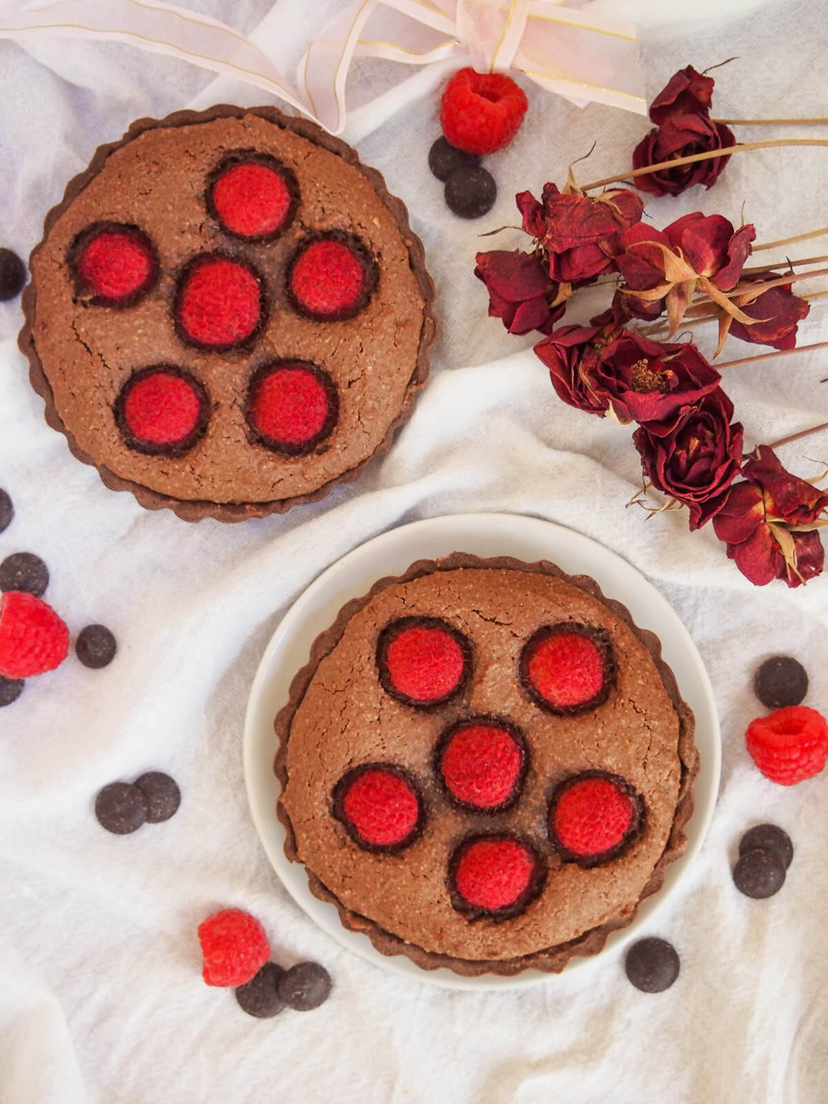 two chocolate almond tarts with raspberry from overhead