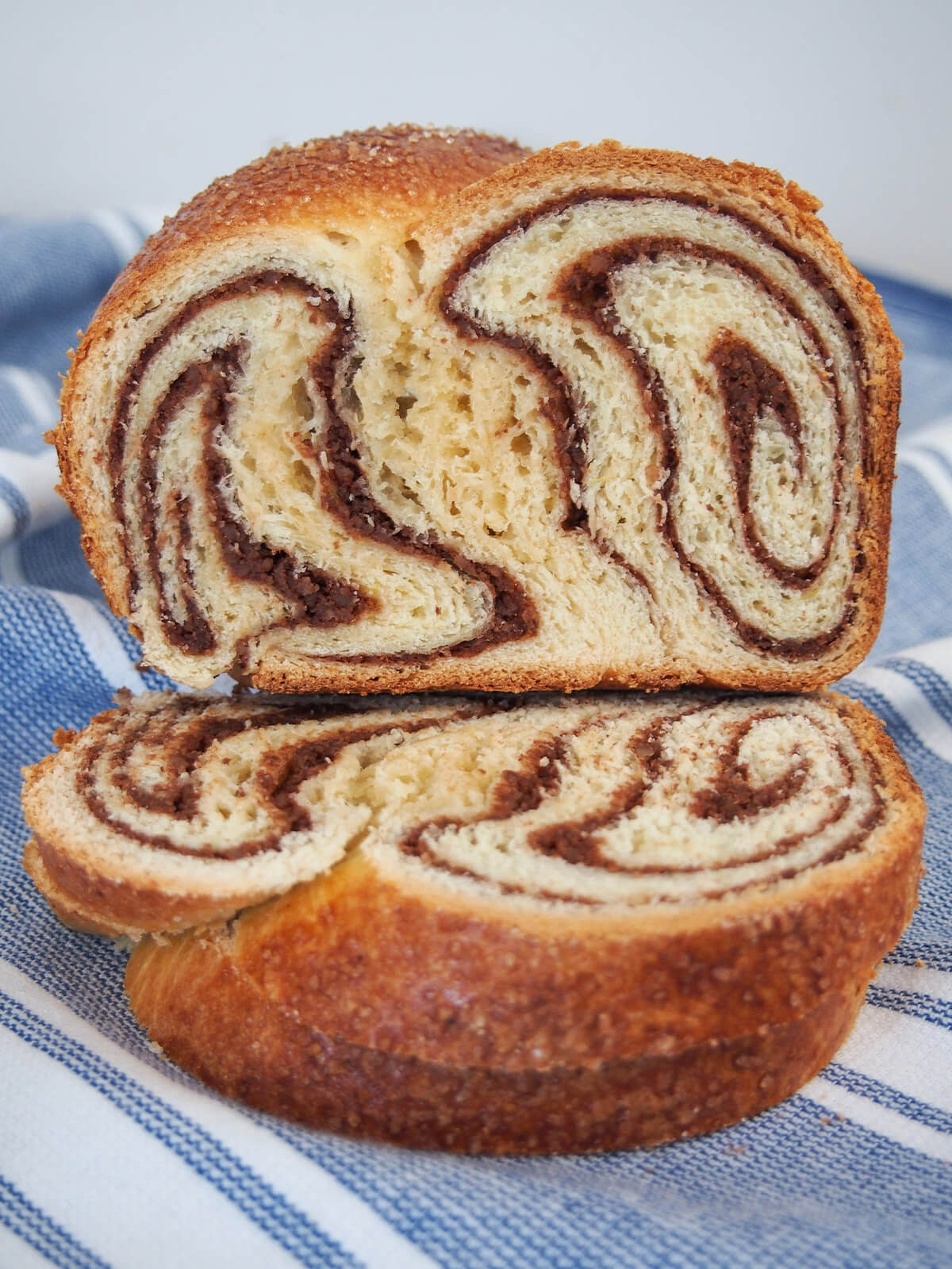 end of cozonac loaf sitting on two slices showing swirled patern