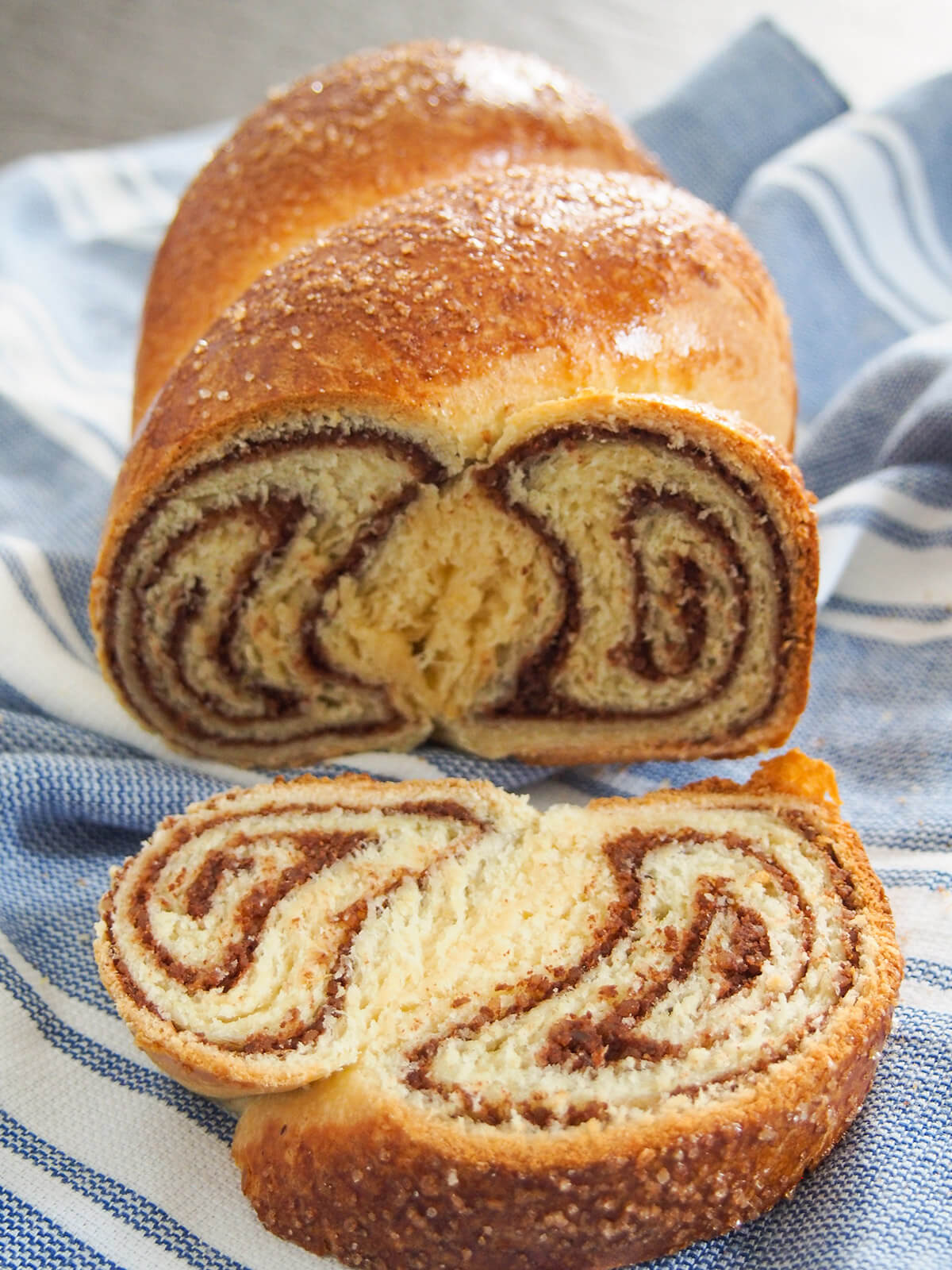 slice cut from cozonac Romanian Easter bread with rest of loaf behind