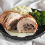 haggis stuffed chicken Balmoral on plate with sides behind