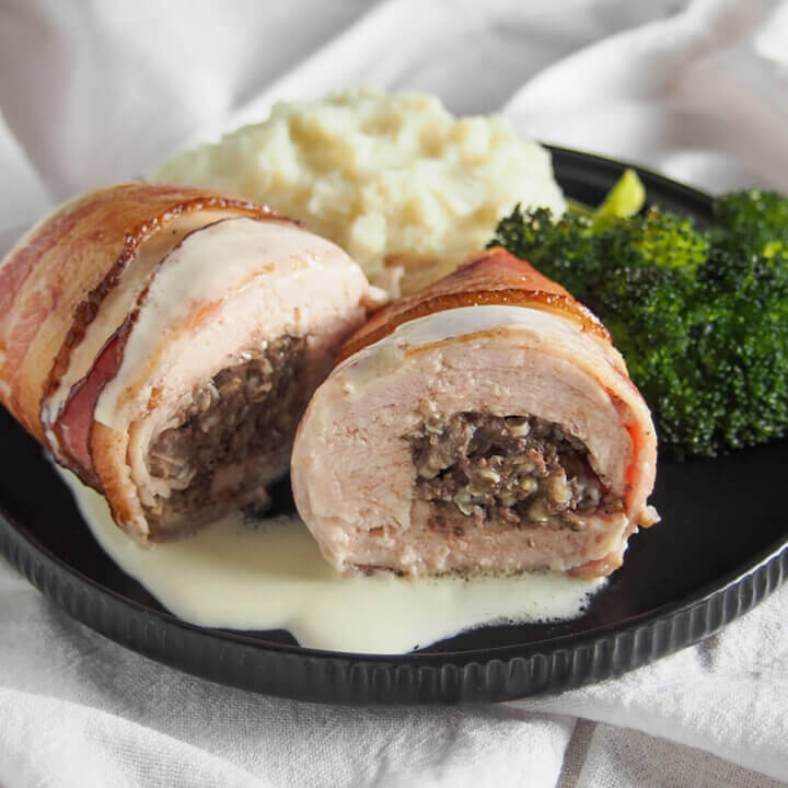 haggis stuffed chicken Balmoral on plate with sides behind