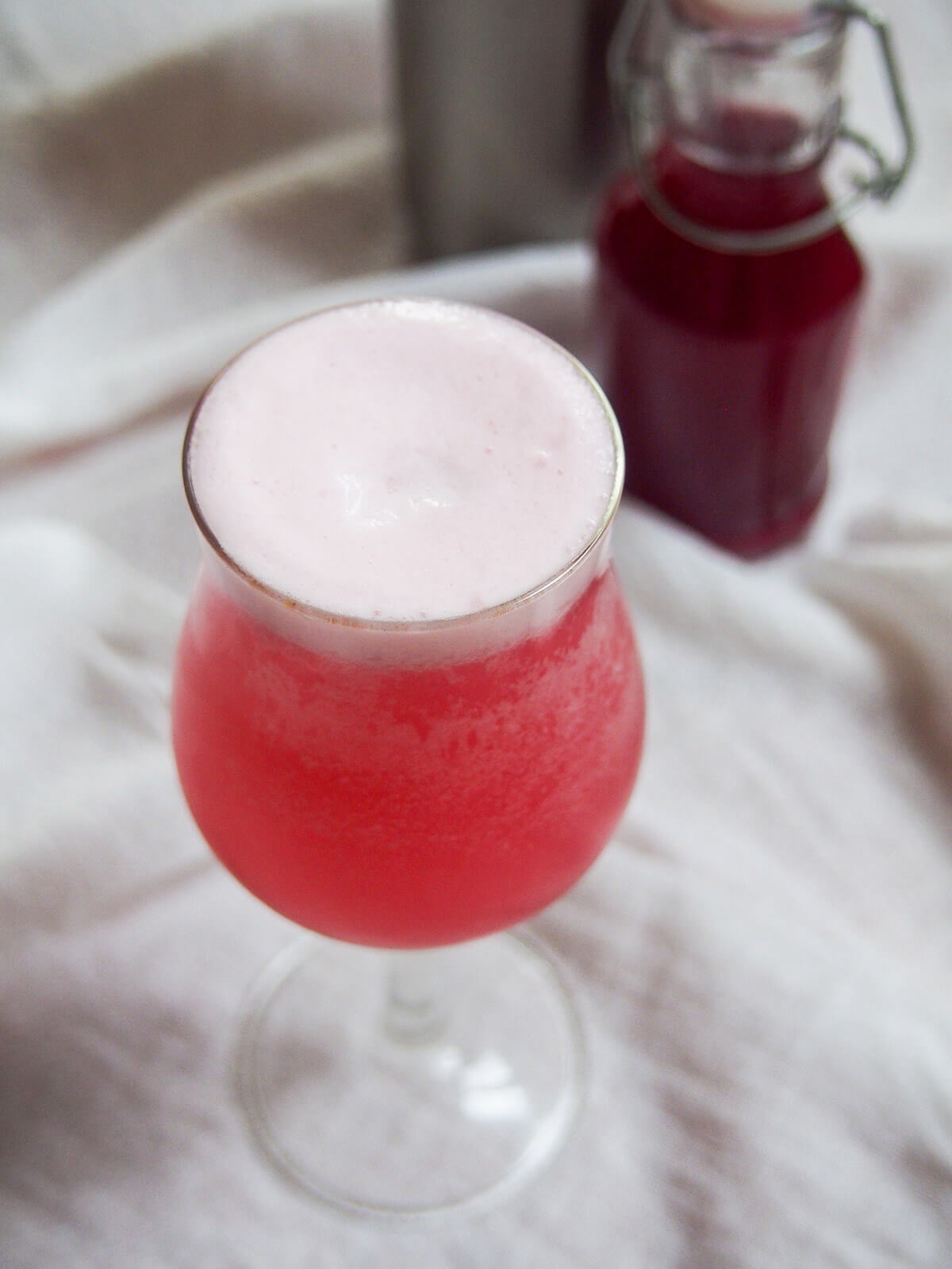 looking at foamy top of glass og pink gin fizz