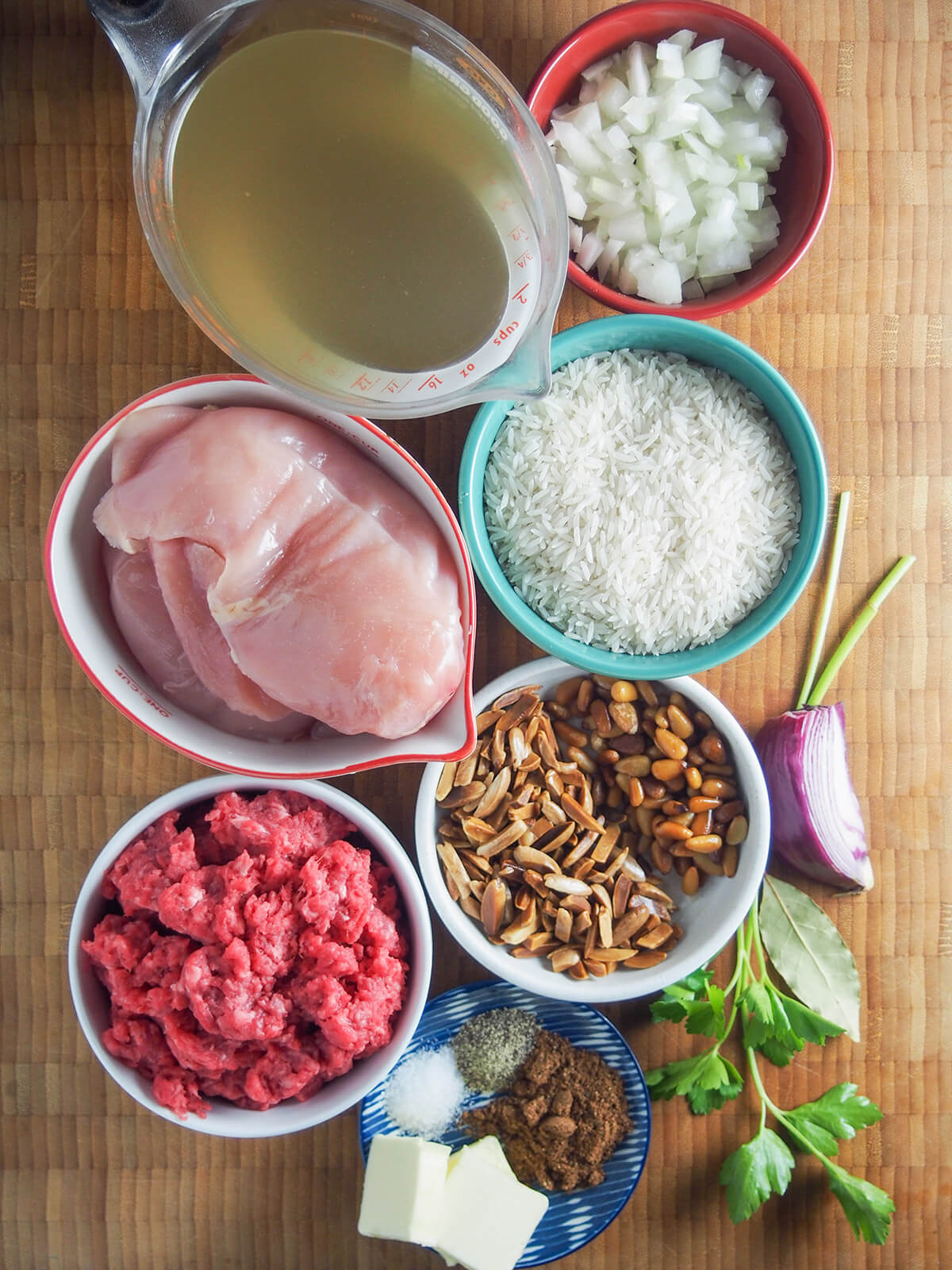 bowls with rice, chicken, ground meat, onion, stock, nuts and spices