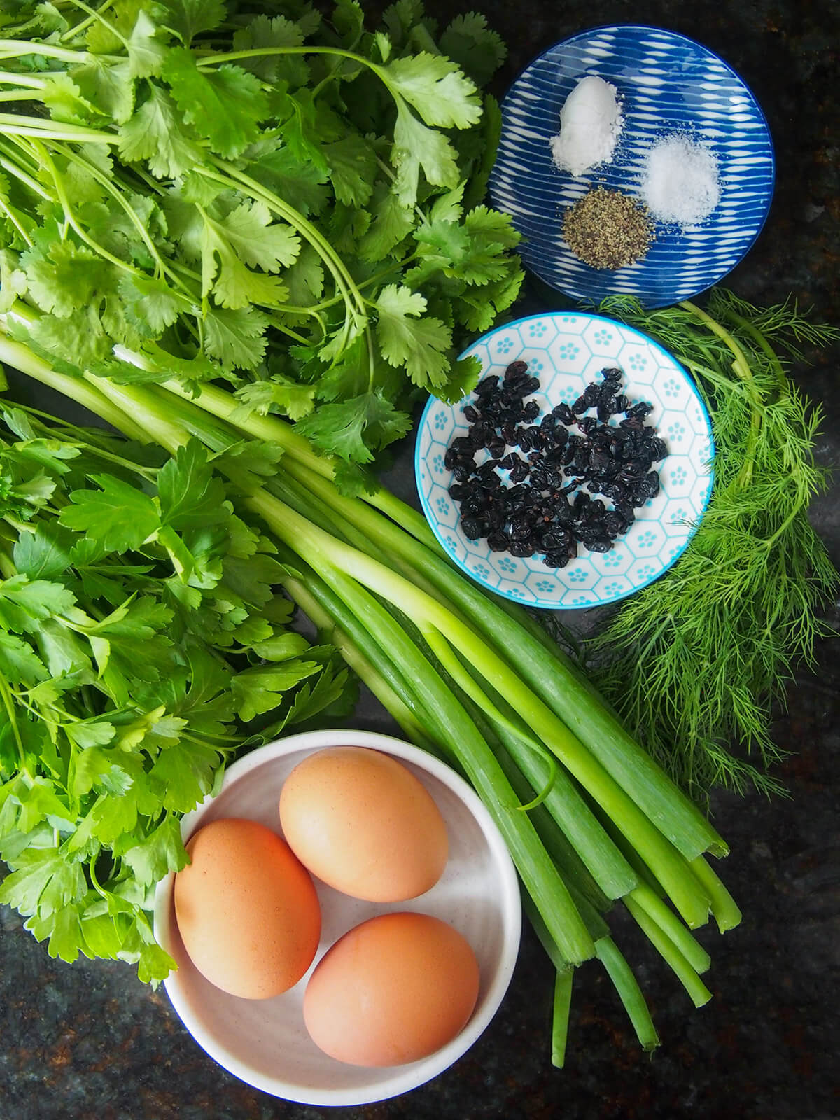 bunches of herbs, scallions, eggs and barberries