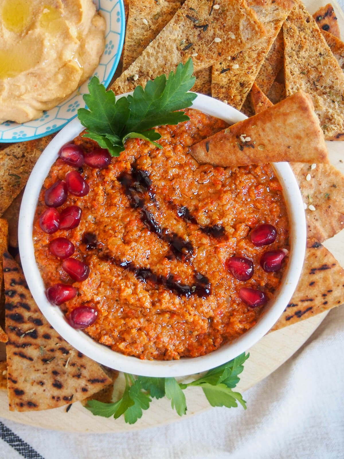 dish of muhammara garnished with pomegranate seeds from overhead