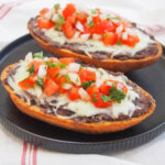 two slices of Mexican molletes on plate