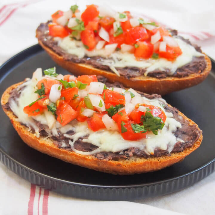 two slices of Mexican molletes on plate