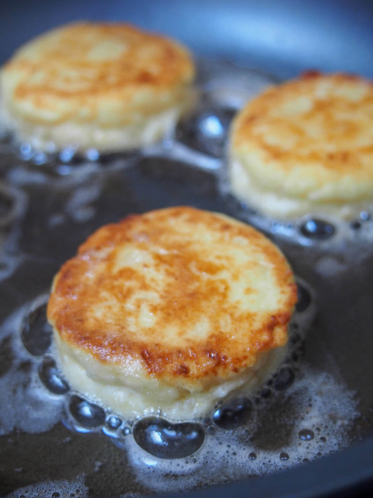 cooking cheese pancakes in skillet