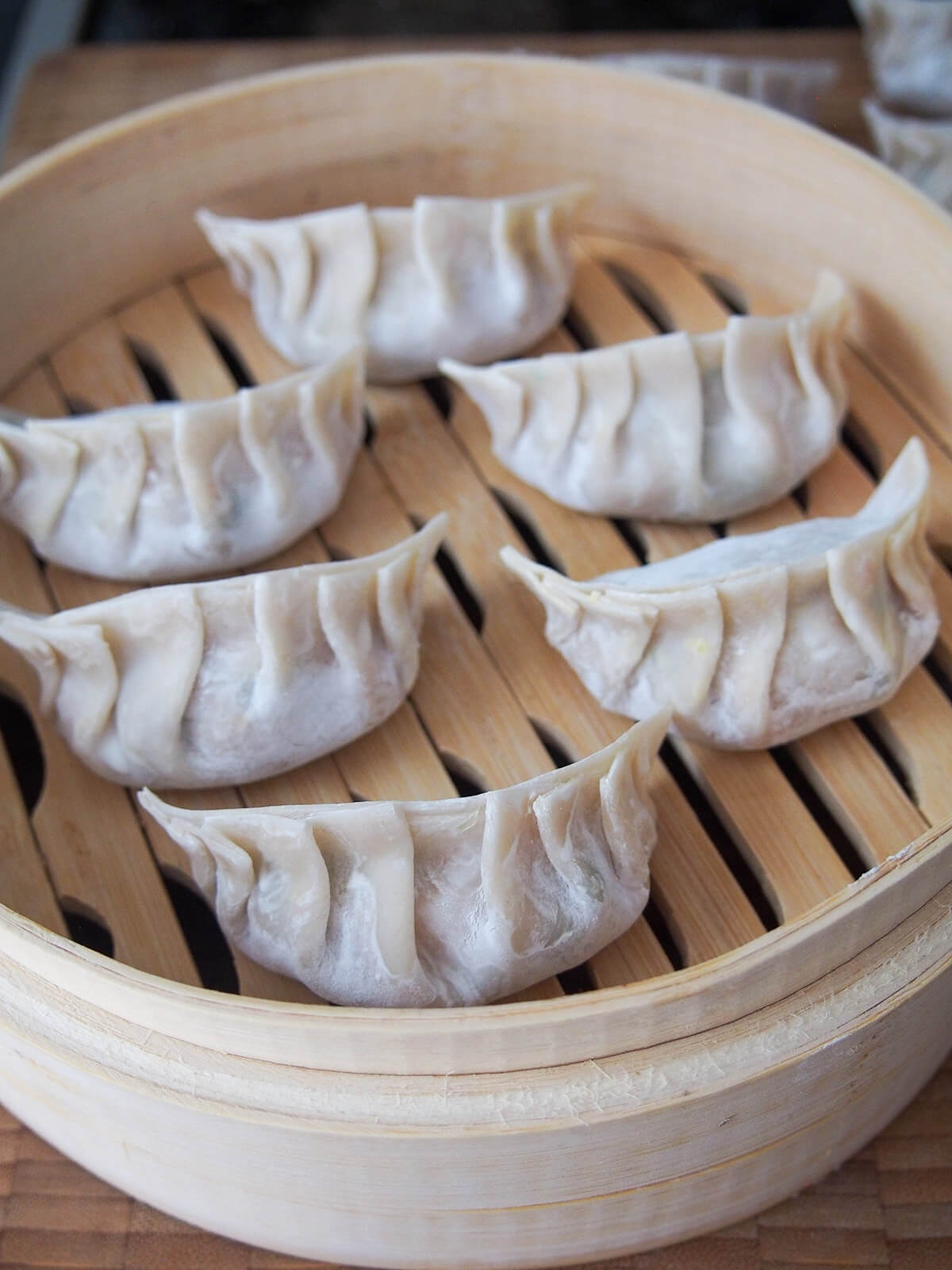uncooked dumplings in steamer
