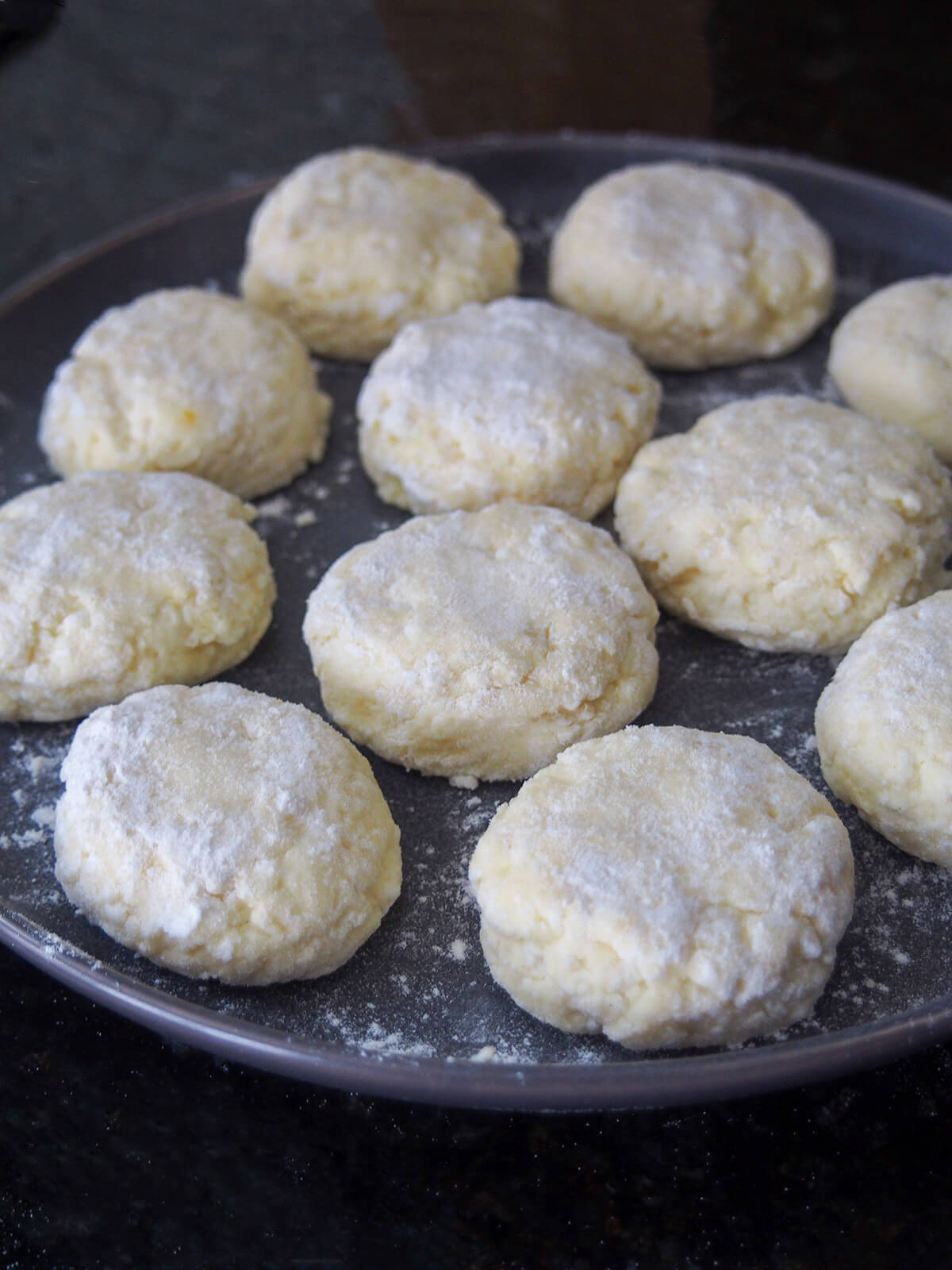 plate with uncooked syrniki on it