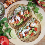 overhead view of two salmon tacos on board