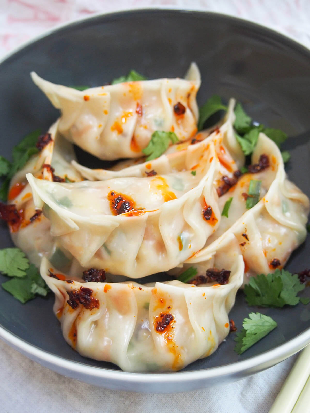 close view of vegetable dumplings jiaozi in grey bowl