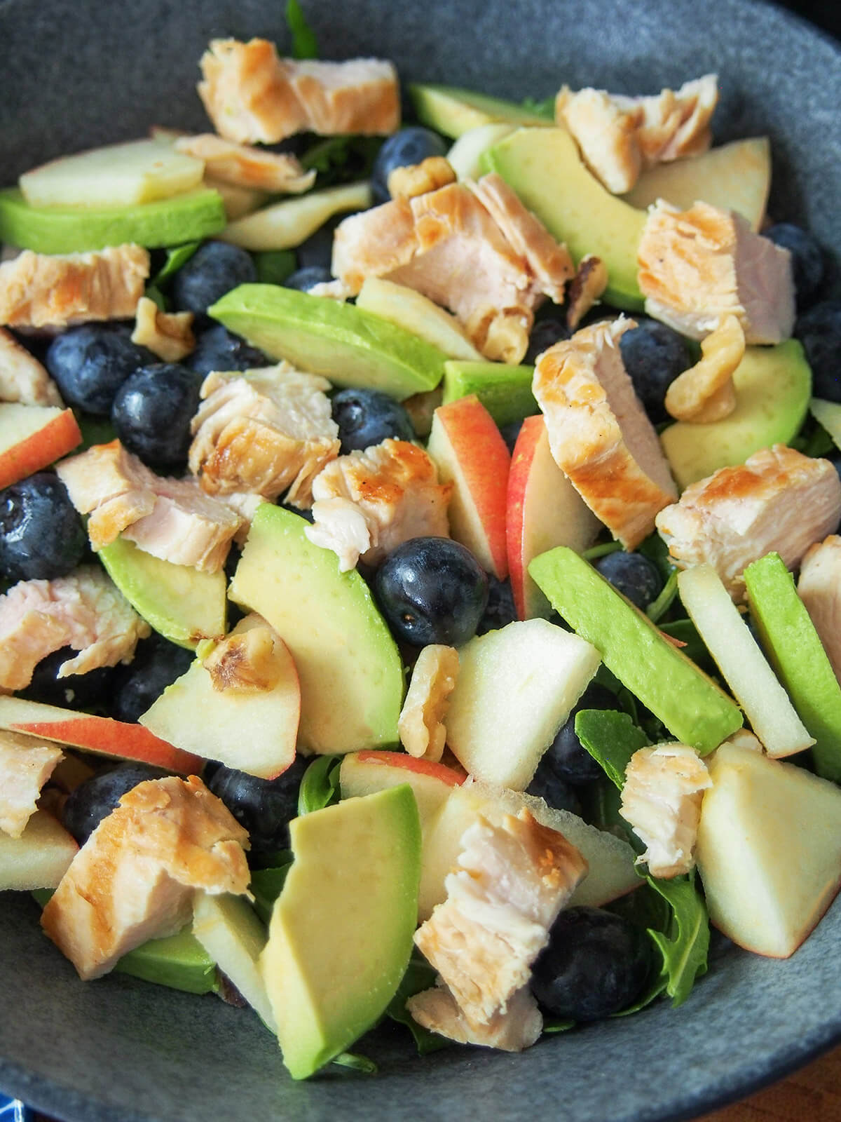 grilled chicken blueberry salad ingredients in bowl before adding dressing