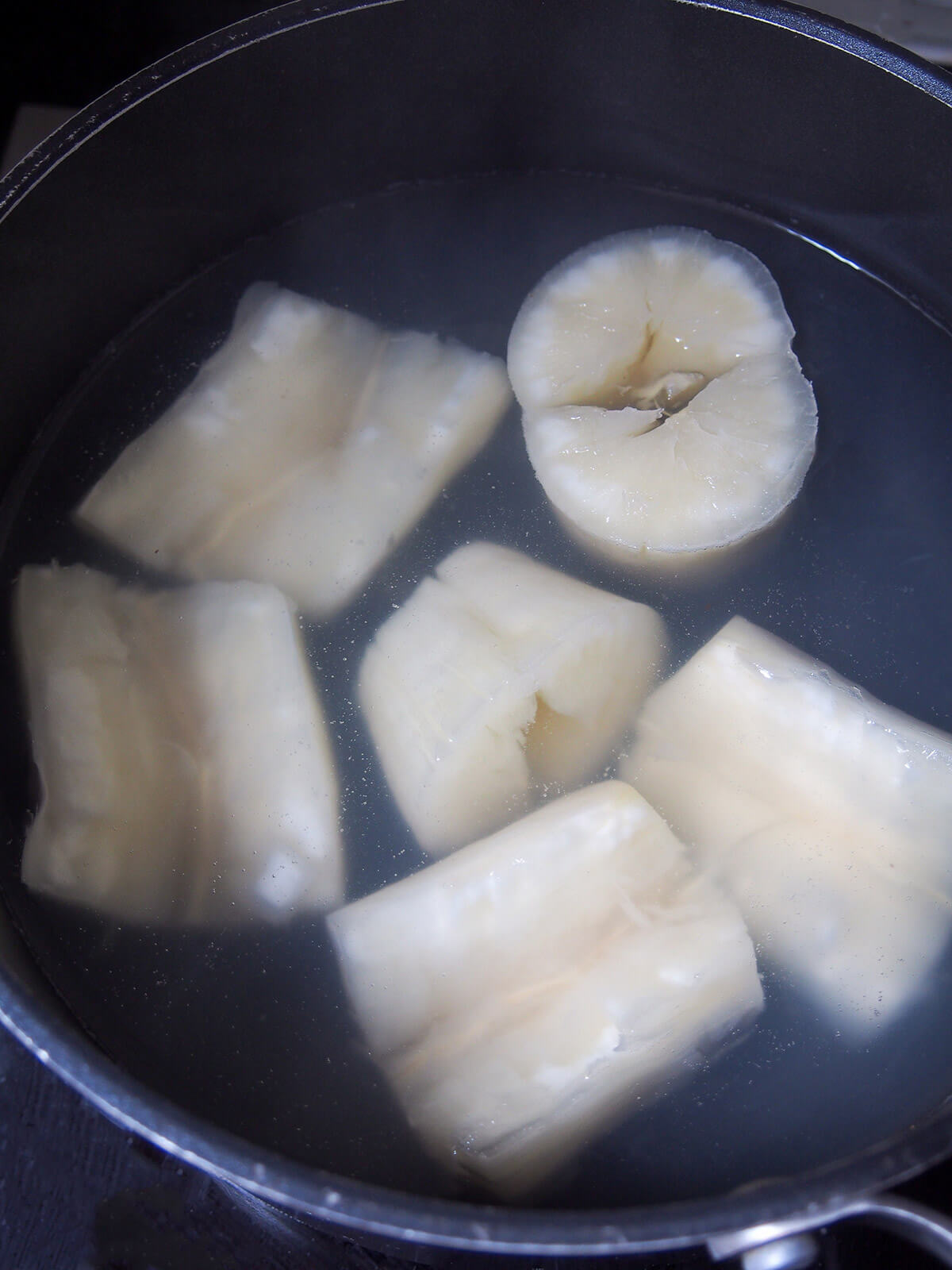 sections of yuca in pot of water