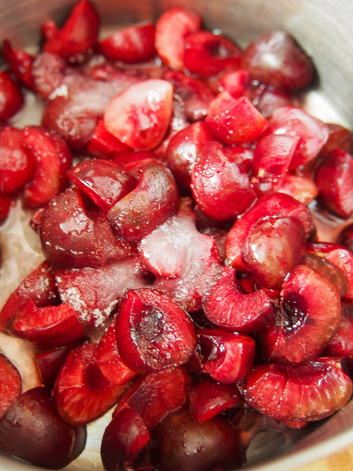 chopped cherries in small pan with sugar and lemon