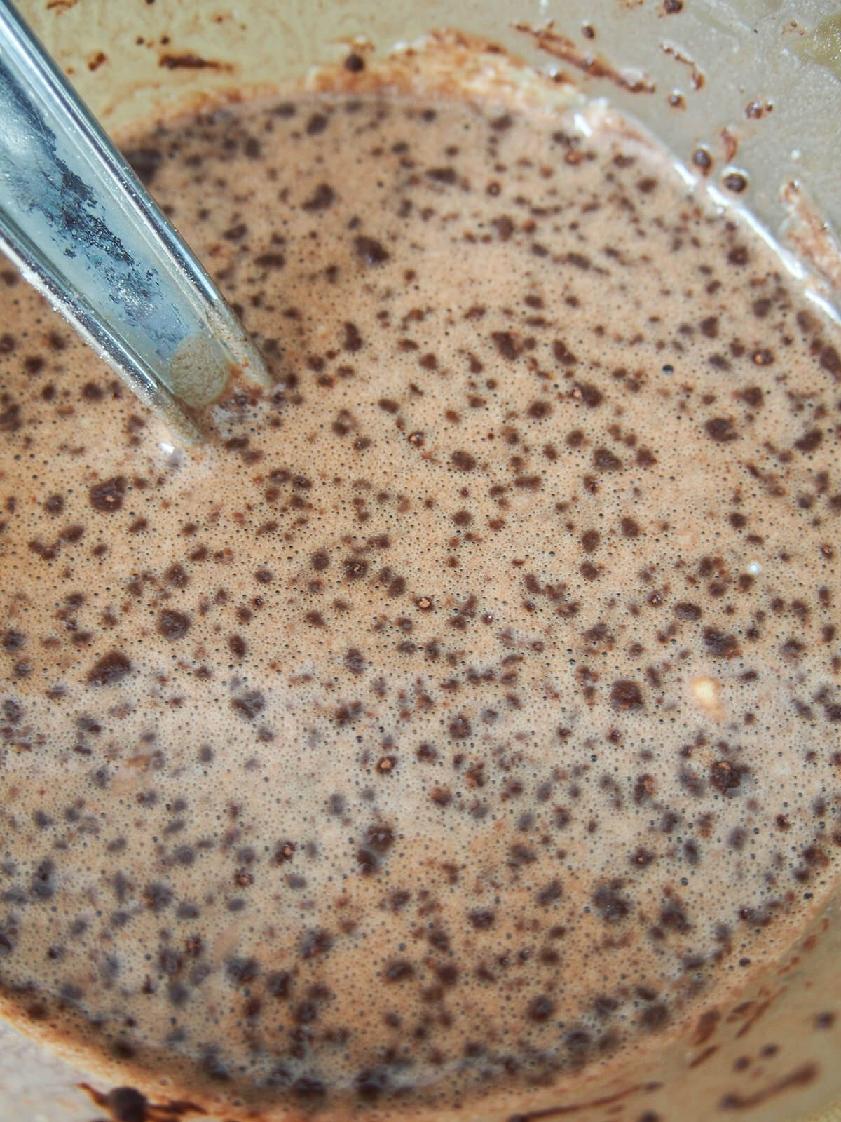 chocolate pancake batter in bowl with specks of chocolate on top