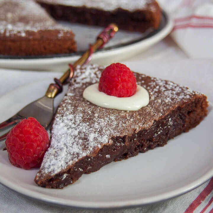 slice of kladdkaka Swedish sticky chocolate cake on plate with fork to side