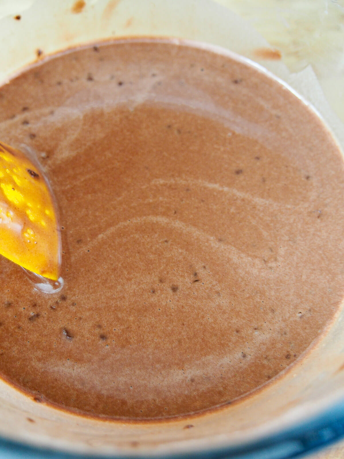 chocolate pancake batter with spatula to side of bowl