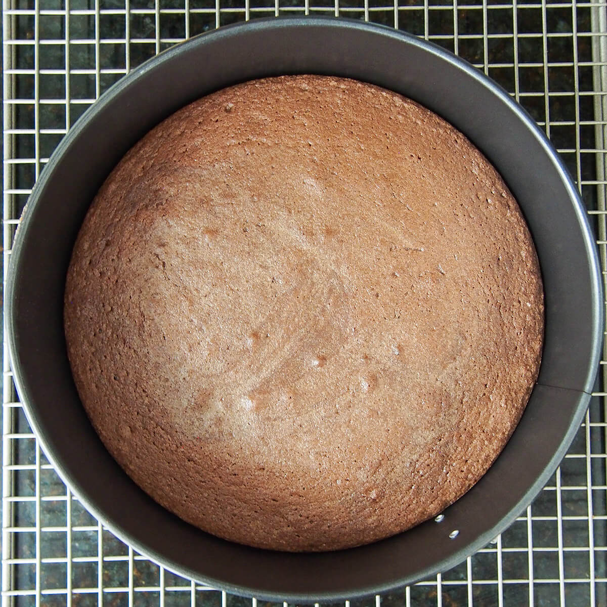 kladdkaka chocolate cake in baking tin on cooling rack