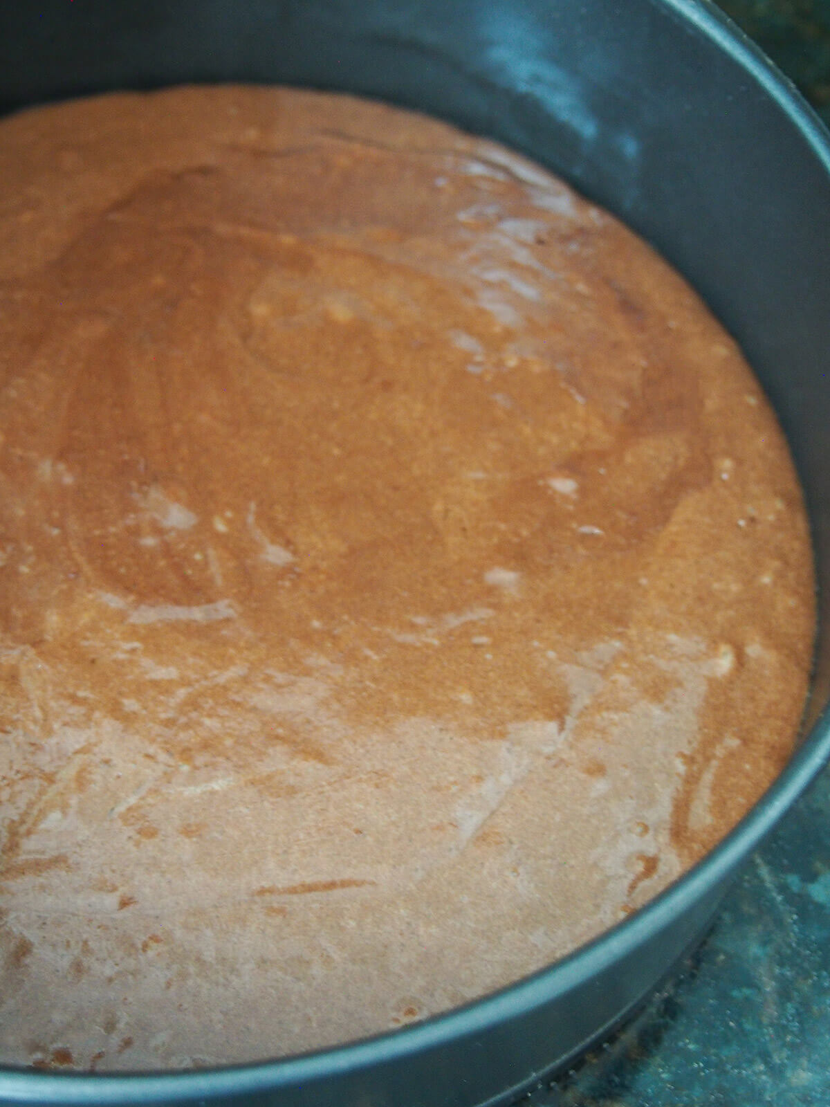 cake batter in tin before baking