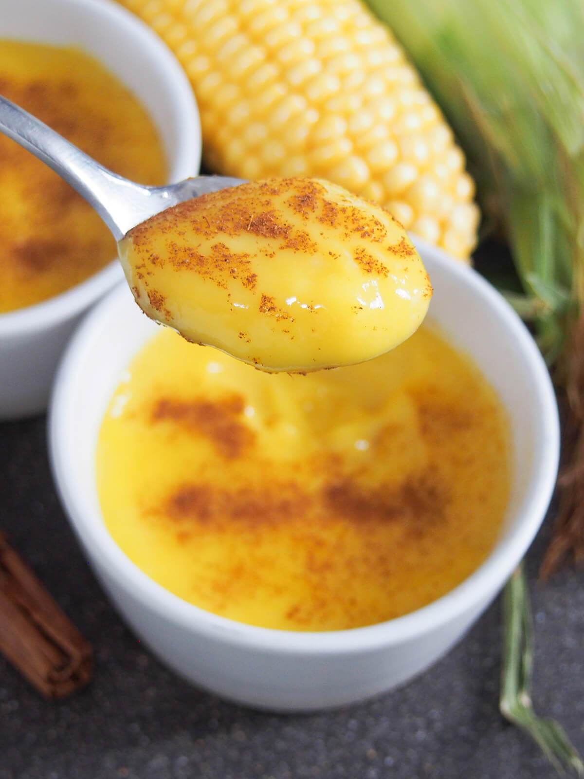 spoonful of Brazilian corn pudding held over dish
