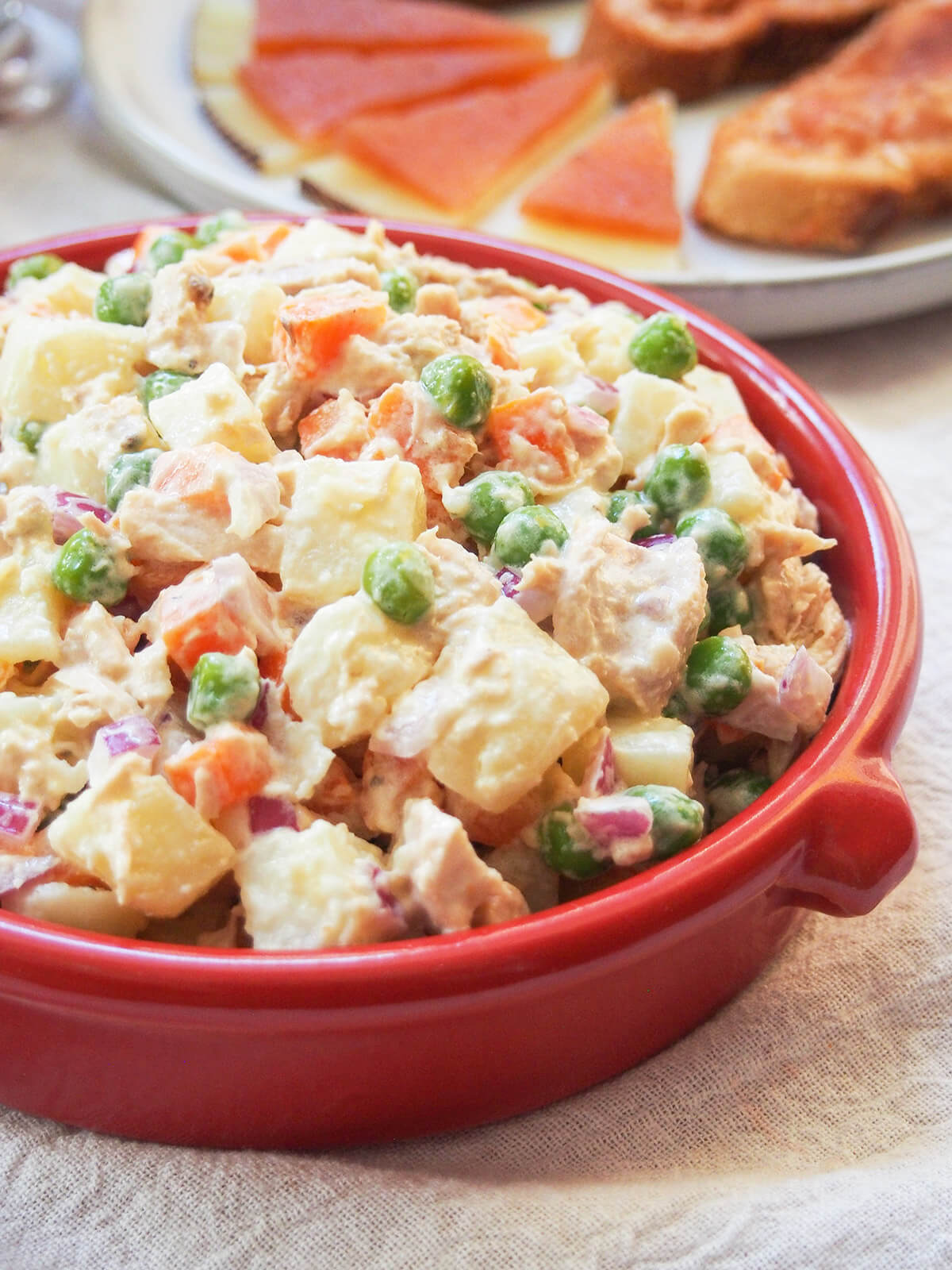 ensalada rusa or Olivier salad in terracotta dish from side