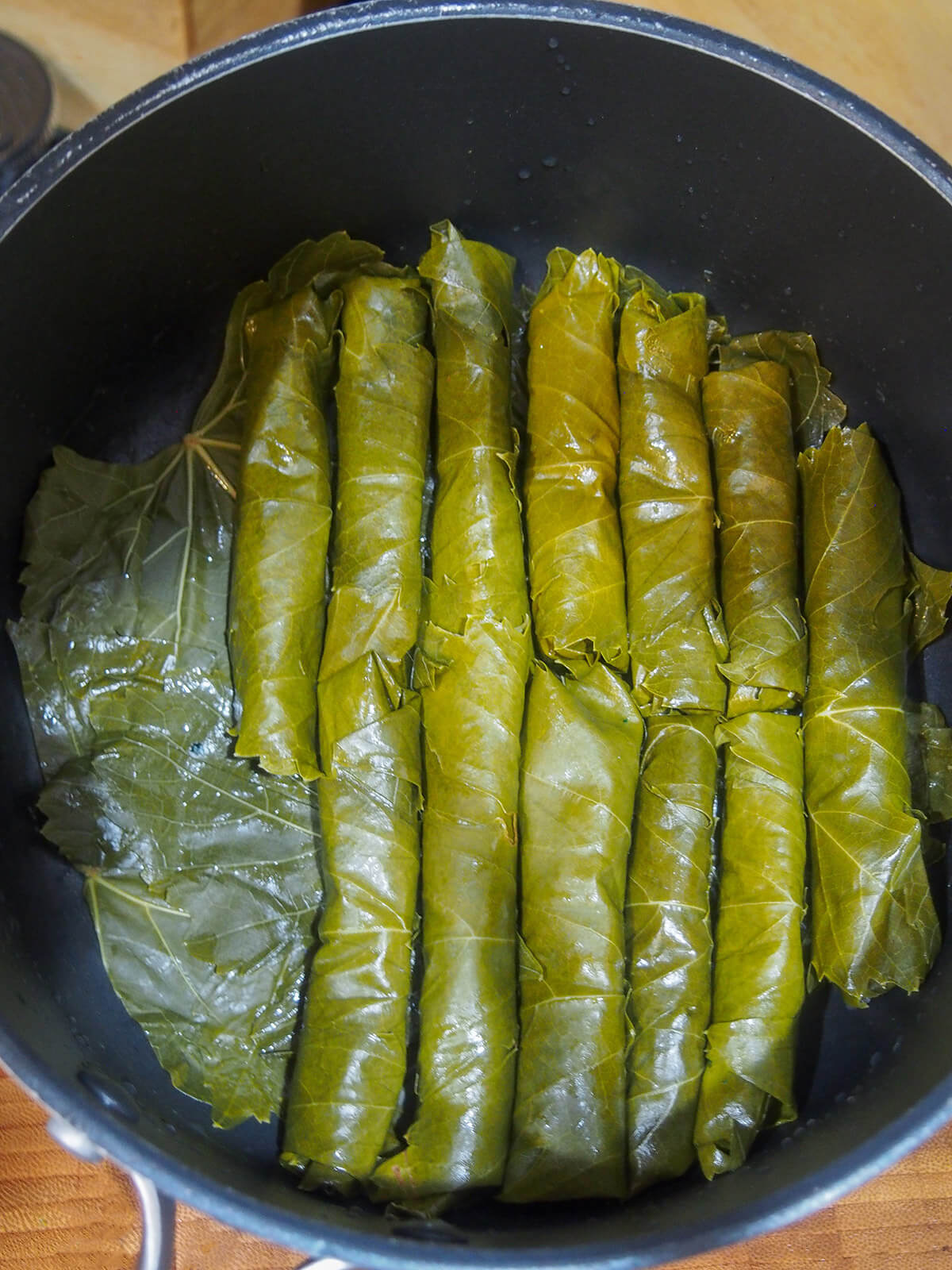 layering rolled grape leaves in pot
