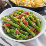 bowl of German green beans Speckbohnen with spaetzle in background