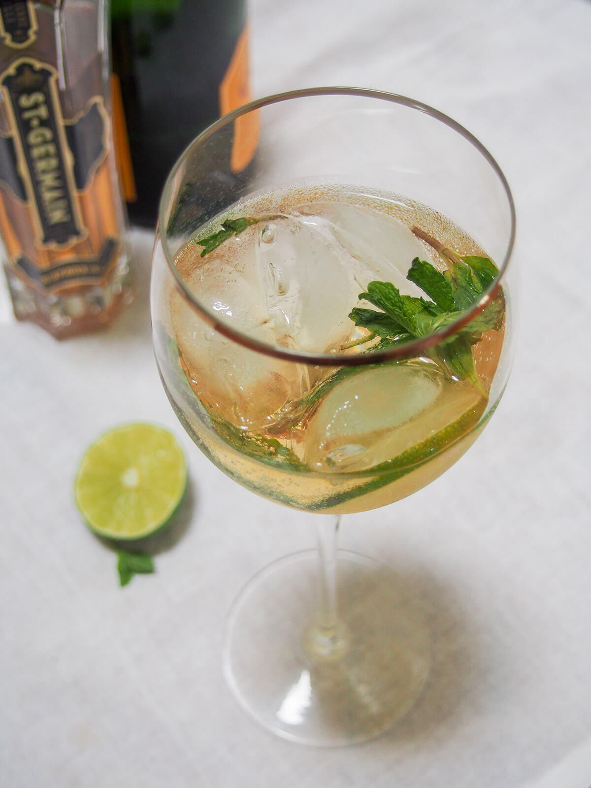 glass of Hugo spritz cocktail with mint garnish in glass