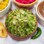 bowl of beans thoran with green chili to side