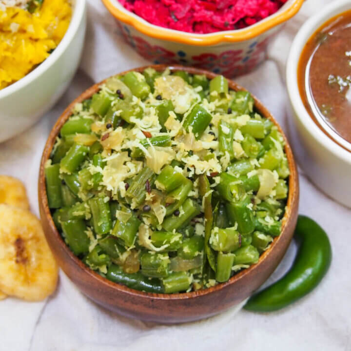 bowl of beans thoran with green chili to side